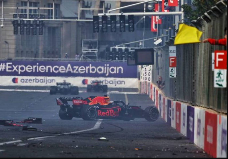 Marshal waving a yellow flag beside the track